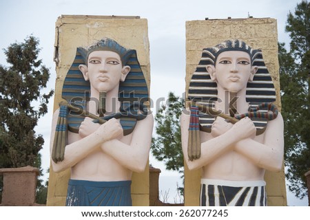 QUARZAZATE, MOROCCO, MARCH 8, 2014. Egyptian statues standing on the front faÃ§ade of the famous Studios Cinema moviee studios and Hotel Oscar, in Quarzazate, Morocco, on March 8th, 2014.