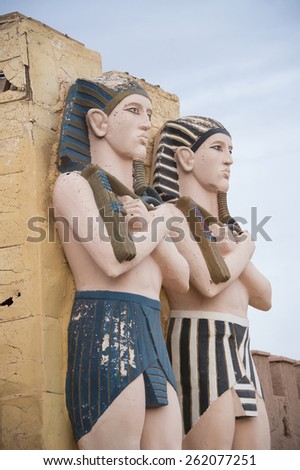QUARZAZATE, MOROCCO, MARCH 8, 2014. Egyptian statues standing on the front faÃ§ade of the famous Studios Cinema moviee studios and Hotel Oscar, in Quarzazate, Morocco, on March 8th, 2014.