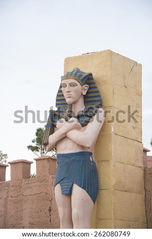 QUARZAZATE, MOROCCO, MARCH 8, 2014. An Egyptian statue standing on the front faÃ§ade of the famous Studios Cinema moviee studios and Hotel Oscar, in Quarzazate, Morocco, on March 8th, 2014.
