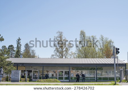 ROIHUVUORI, HELSINKI, FINLAND, MAY 15, 2015. People walking in and out of the mosque and talking in front of the mosque n Roihuvuori, Helsinki, on May 15th, 2015.