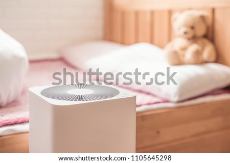 air purifier in bed room. air cleaner removing fine dust in house.