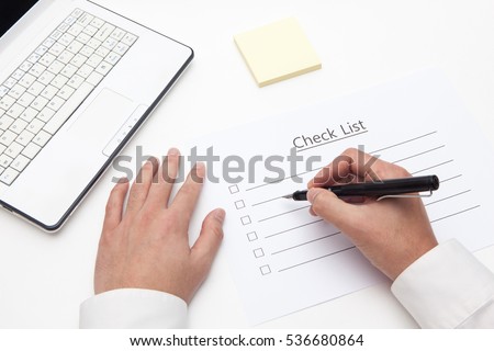 man hand write on check list sheet with fountain pen, notebook, memo paper on white backgrounds