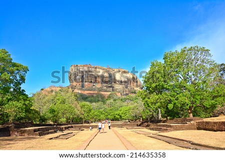 SIGIRIYA, SRI LANKA - 03 AUGUST, 2014: Group of unidentified locals & foreigners walking in garden complex of Sigiriya rock fortress.  Sigiriya is UNESCO listed World Heritage Site