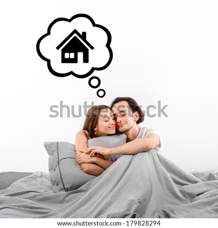 Happy couple in bed thinking and dreaming about house on white background