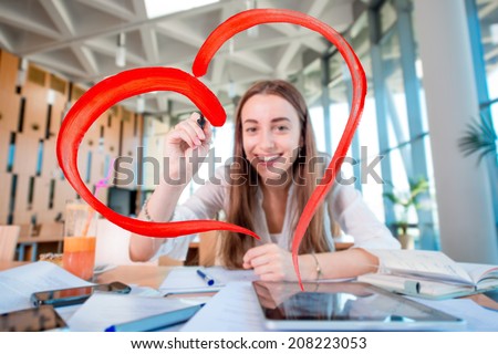Girl drawing heart shape in the University class