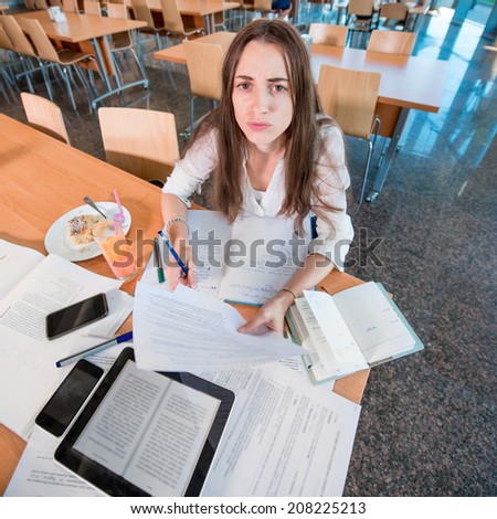 Girl studying hard at the University canteen
