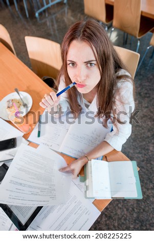 Girl studying hard at the University canteen