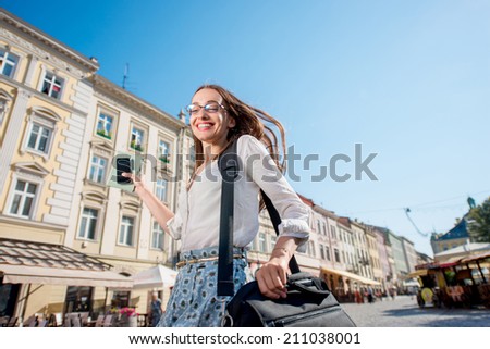 Young woman hurry to the work on the morning in the old city