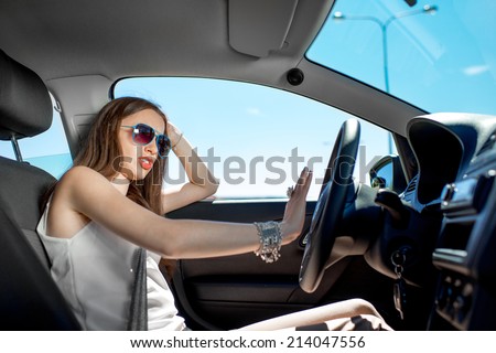 Young elegant woman hurry to work while standing in traffic