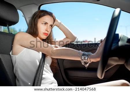 Young sad woman hurry to work while standing in traffic