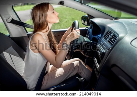Young woman learning to drive car