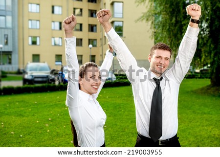 Young business couple having fun outdoor on green background