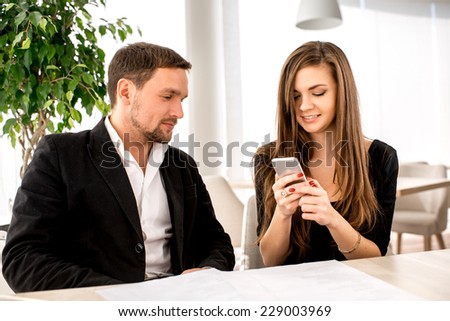 Young couple being busy using their smart phones at the restaurant