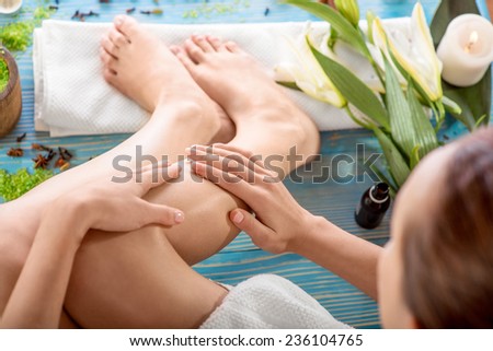 Taking care oiling legs in spa salon. Woman taking spa procedures