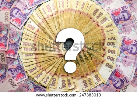 Pile of ukrainian money, hundred and two hundred banknots with question mark