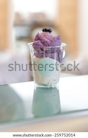 Home made ice cream with blueberries in the plastic cup