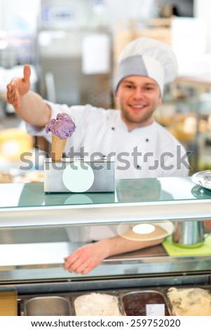 Confectioner selling ice cream in the pastry shop