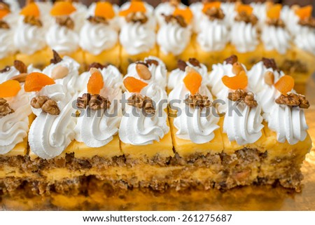 Many slices of fruit creamy cakes with mango and nuts