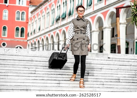 Young woman walking with travel bag down stairs at the Republic square in Split city