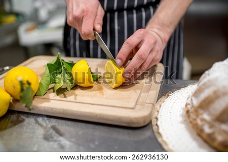 Man cutting lemons on the kitchen table