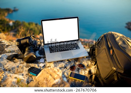 Travel photographer equipment on rocky mountain with beautiful landscape on the background Travel photographer equipment on rocky mountain with beautiful landscape on the background