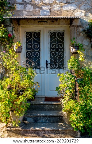 Vintage old house door with flowers and stairs