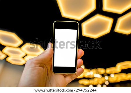 Male hand holding phone with white screen on the modern light background. Scientific mobile program concept
