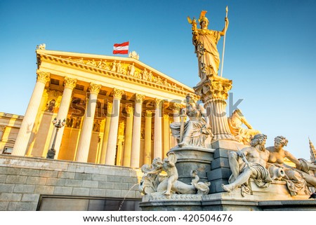 Austrian parliament building with Athena statue on the front in Vienna on the sunrise