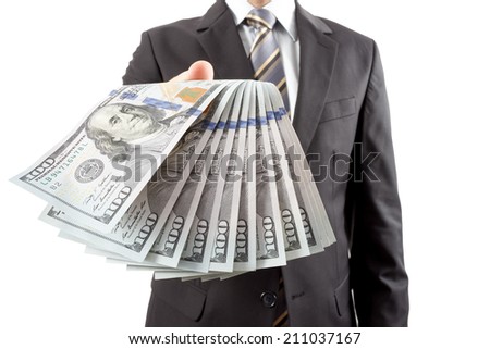 A businessman in a suit giving new dollar money