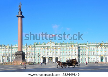 Snt. Peterburg, Russia, September, 27,2014. Russian scene: People in the wagon, drawn by two brown horse ride  Palace square near the Alexander column