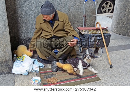 Aosta, Italy, May, 10, 2013. The man, who asks alms for animal feed