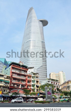 Saigon, Vietnam, January, 20, 2015. People on mopeds, motorcycles and cars, near the Bitexco tower in Saigon