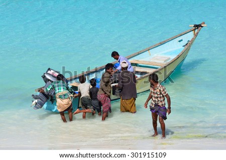 Sokotra,Yemen, March,20,2014. Sokotra scene:  Men near the boat in Shuab Bay, Arabian sea