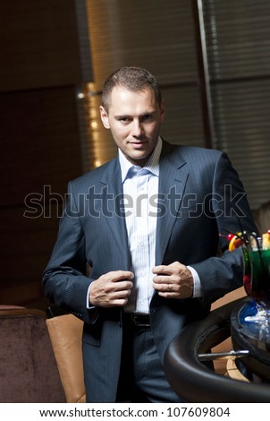 Man in suit standing  in the hotel lobby.