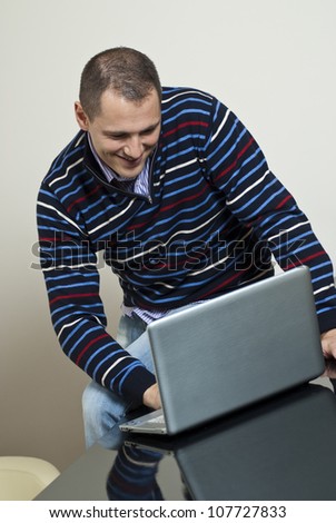 Yang man works with laptop.