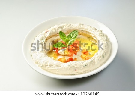 The traditional Middle Eastern , hummus with mint leaf.