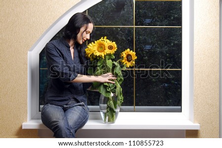 Portrait of yang and beautiful brunette in front of the window