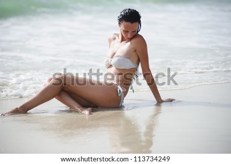 Yang and beautiful  European woman relaxing in the beach alone.