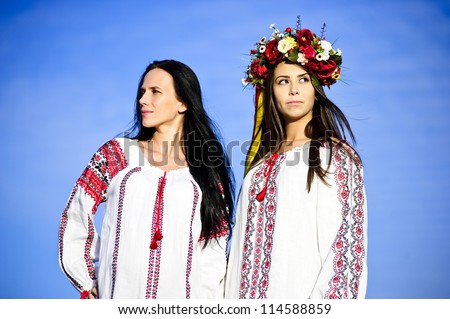 Outdoor portrait of yang and beautiful  Slav girls dressed traditional way.