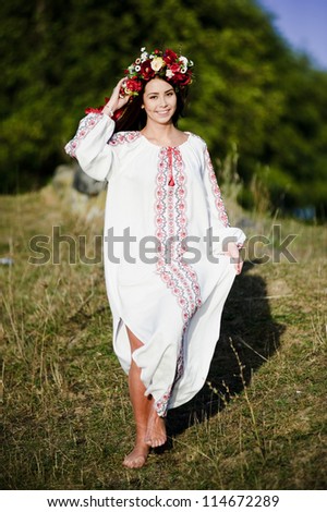Outdoor portrait of yang and beautiful  Slav woman dressed traditional way.
