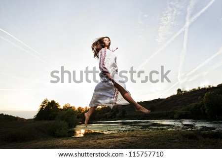 Outdoor portrait of yang and beautiful Slav woman dressed traditional way.