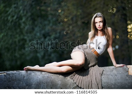 Yang and beautiful sexy woman poses outdoor countryside.