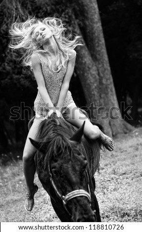 Portrait of yang and pretty female horse rider.
