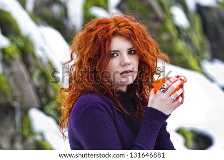 Portrait beautiful red haired woman in winter forest.