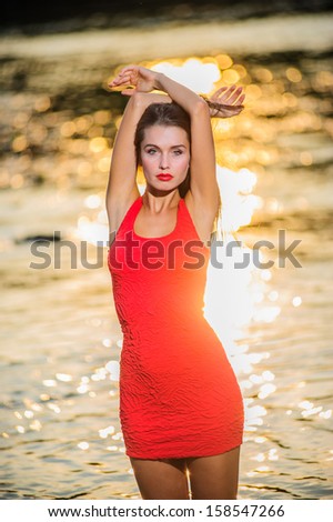 Yang and beautiful sexy woman poses outdoor countryside in sunset time.
