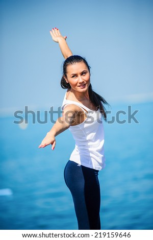 Yang sporty girl enjoying her time on the beach.