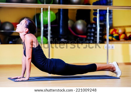 Beautiful woman stretching in the gym.