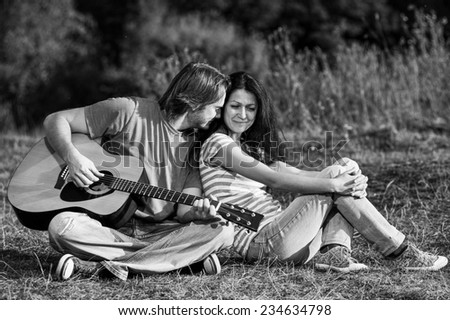 Yang couple with guitar outdoor.Black and white.