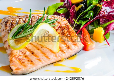 Roasted salmon with ruccola side dish.