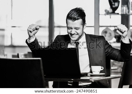 Portrait of yang confident businessman in interior black and white